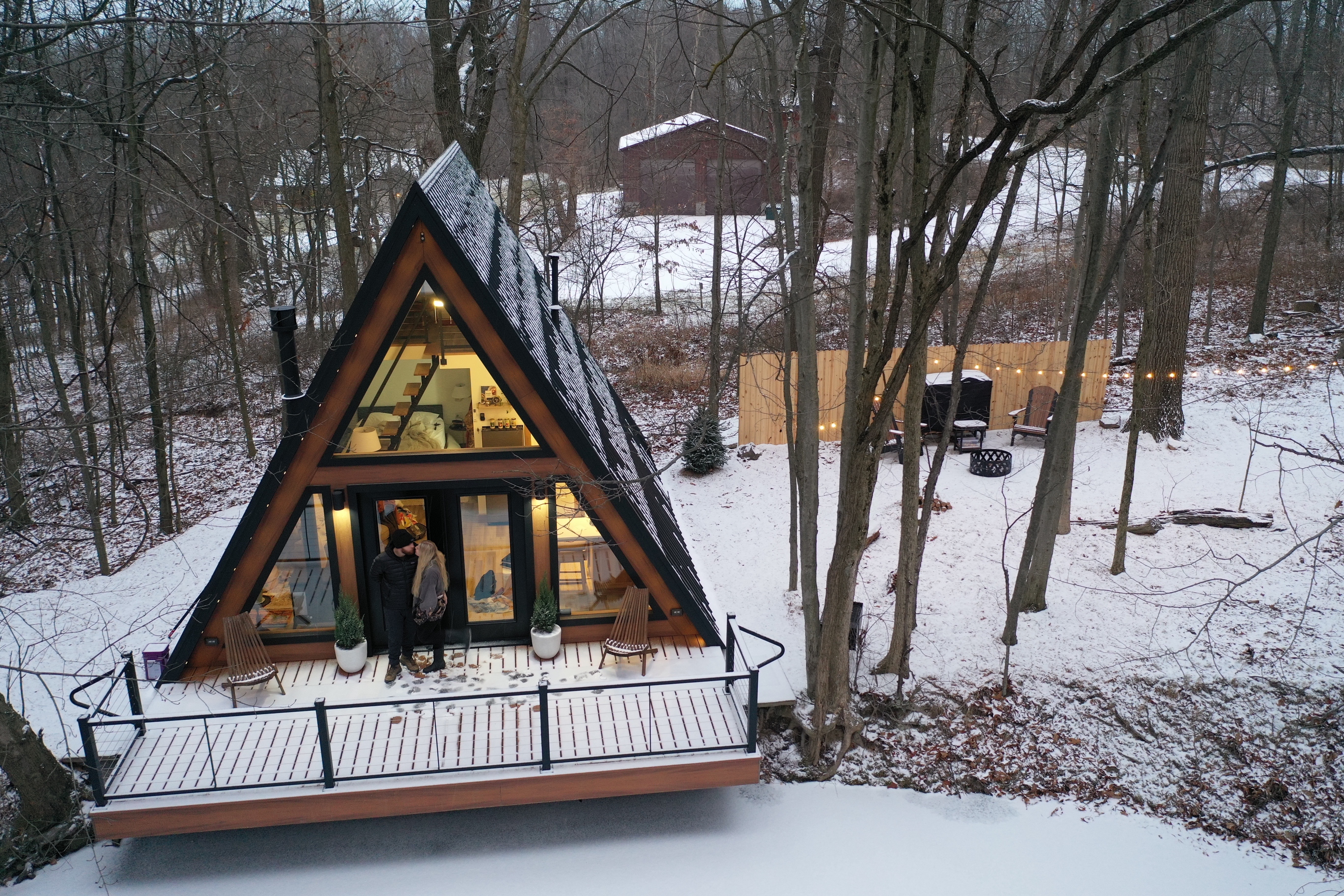 Forest Lane A-Frame glowing in a snowy Ohio forest