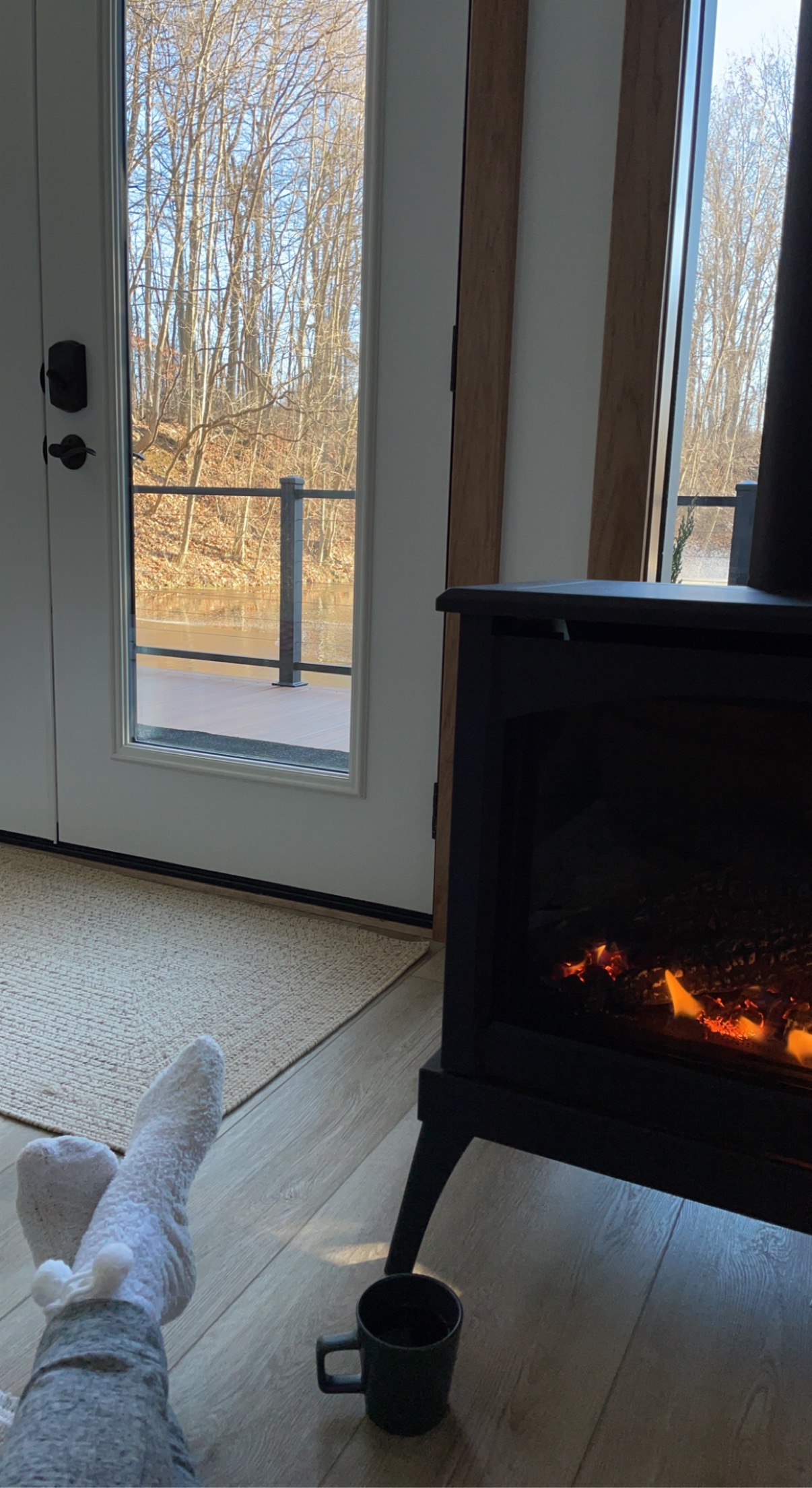 Cozy fireside view toward the wooded deck