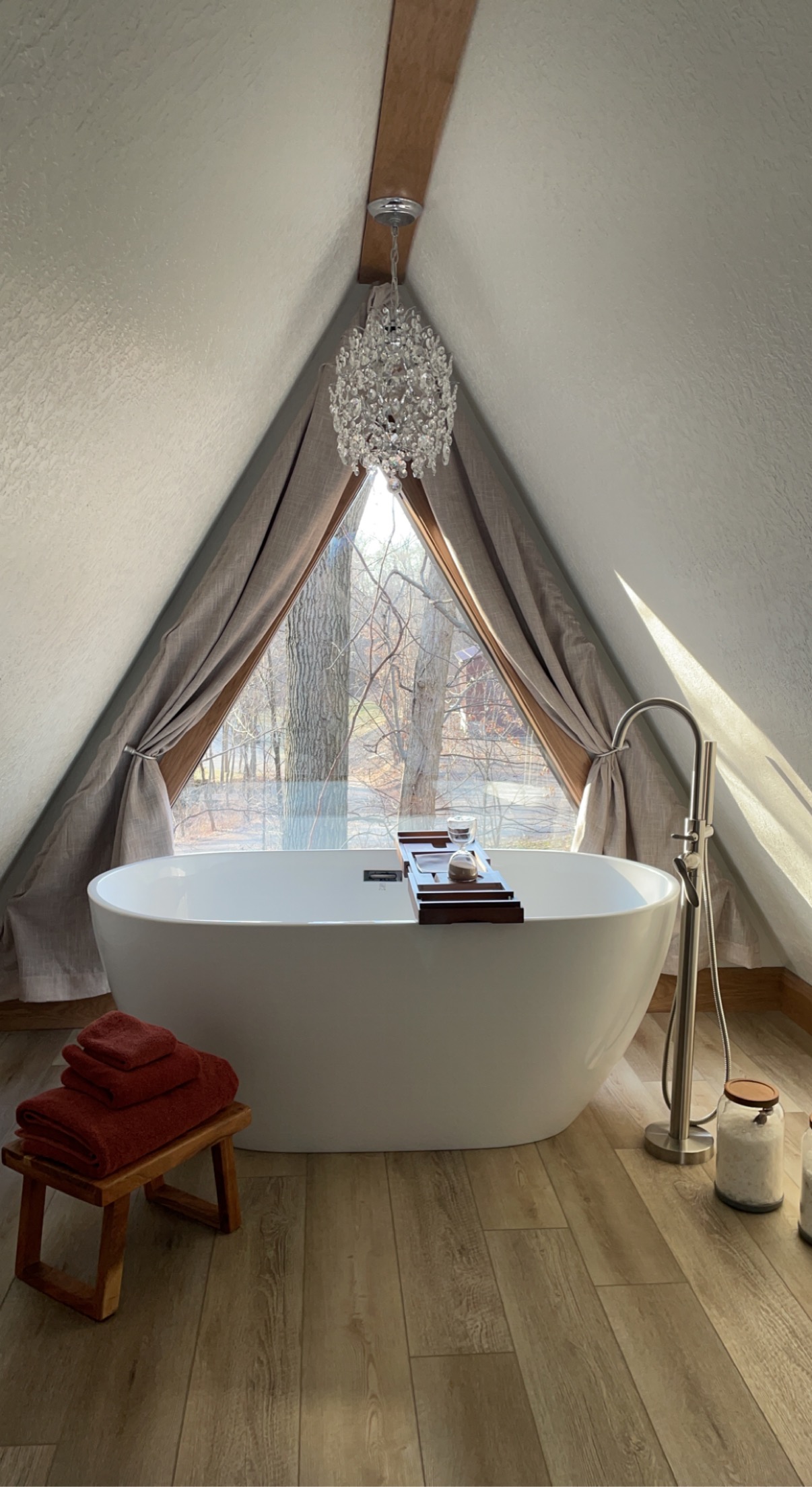 Freestanding bathtub beneath the A-frame window